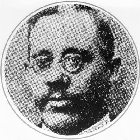 A black and white photograph of Constable Frank Beevers, wearing small round glasses.