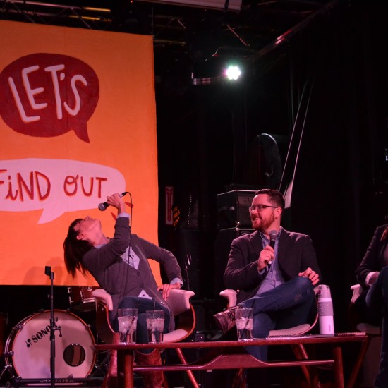 Sarah looks back at the Let's Find Out sign.