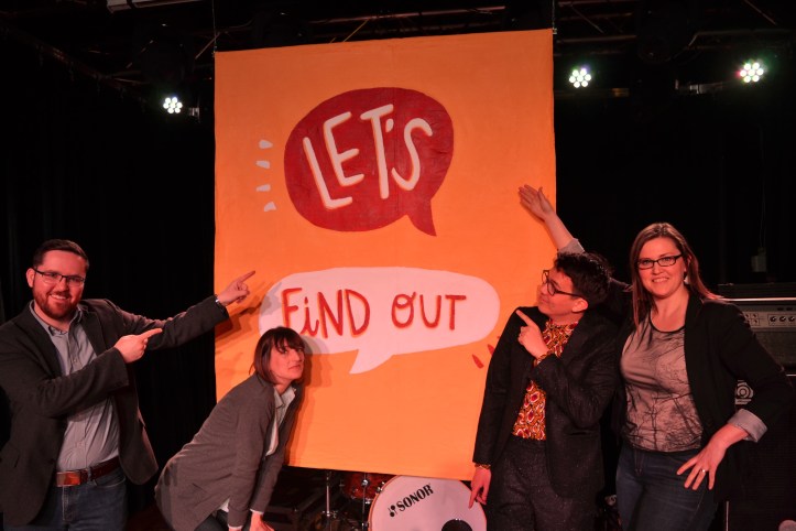 Dave Cournoyer, Sarah Hoyles, Chris, and Kisha Supernant in front of the Let's Find Out sign.