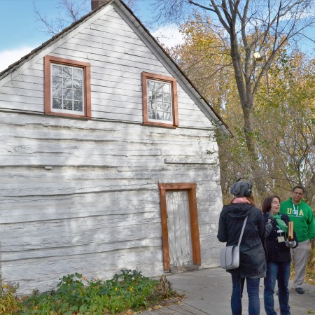 Jade Dodd standing in front of John Walter's first house, which forms part of today's John Walter Museum.