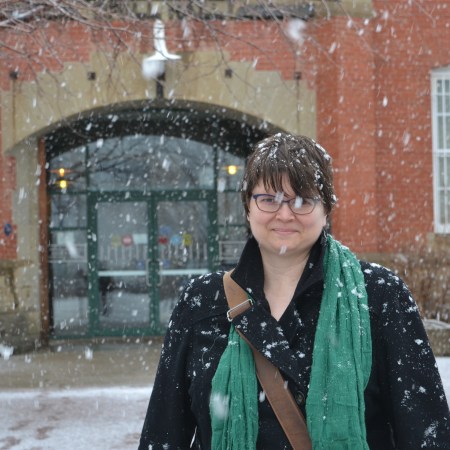 Susan in front of the Prince of Wales Armouries, where the City of Edmonton Archives live. There's a lot of snow.