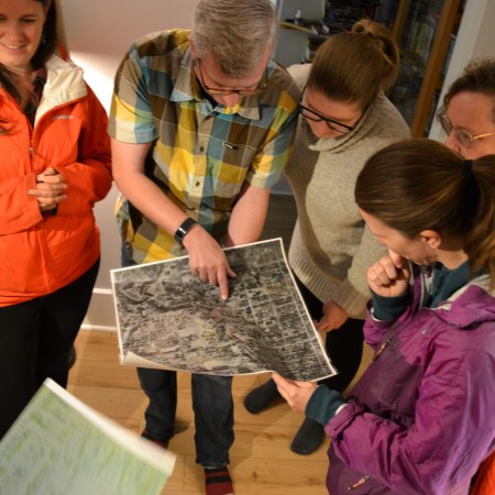 Sam Billings and Nicole Anderson look at the aerial photograph of their house in Ritchie
