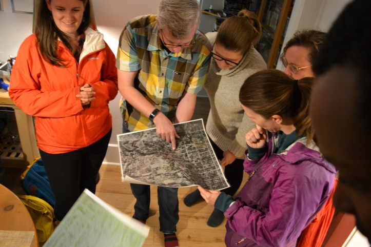 Sam Billings and Nicole Anderson look at the aerial photograph of their house in Ritchie