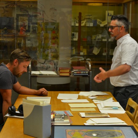 Dustin and Jeff look through materials at the Bruce Peel Special Collections