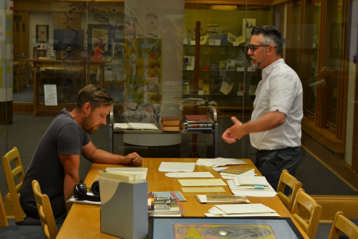 Dustin and Jeff look through materials at the Bruce Peel Special Collections