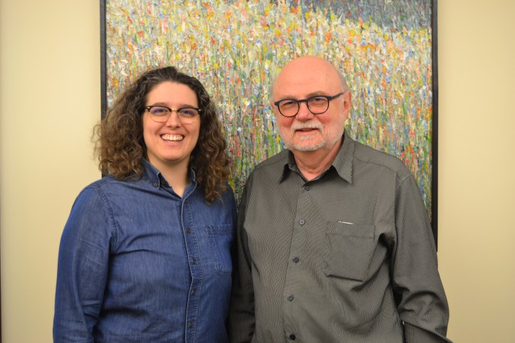 Jars and Alison in front of a pointilist landscape painting