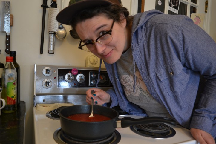Alison bends over a pot of high bush cranberries