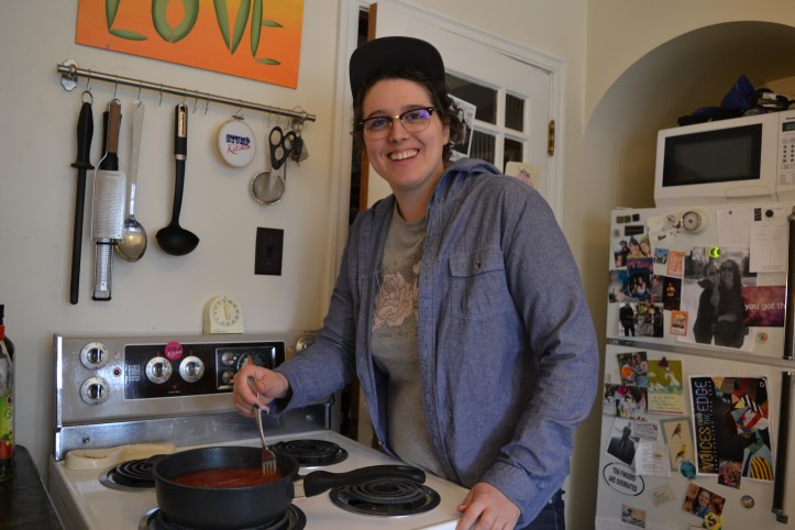 Alison in her kitchen at home, stirring a pot of high bush cranberries