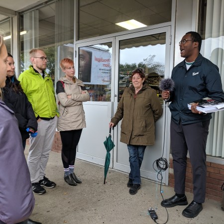 Oumar speaks to the crowd outside K & K Foodliner on Whyte Avenue