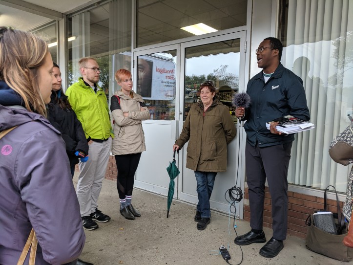 Oumar speaks to the crowd outside K & K Foodliner on Whyte Avenue