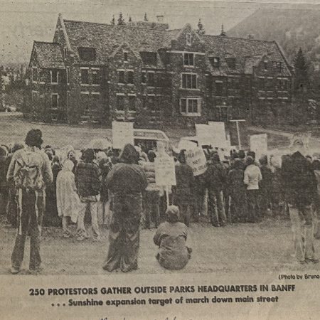 A photo from the Calgary Herald of a group of protesters facing Banff park headquarters.